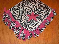 Tied blanket with applique